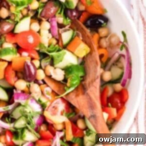 Vibrant Mediterranean Chickpea Medley 9 Mediterranean Chickpea Salad in a white bowl with spoon