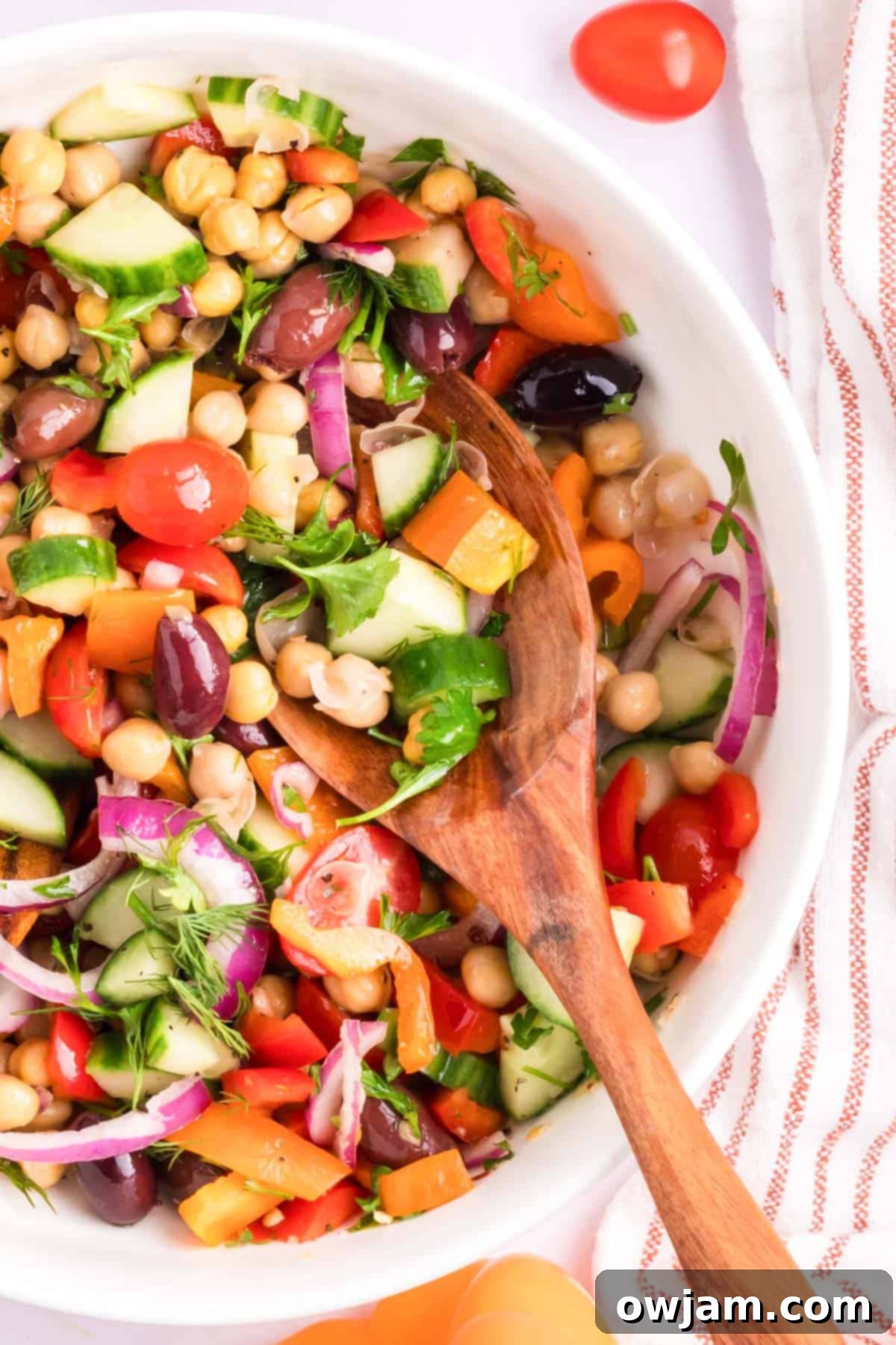 Vibrant Mediterranean Chickpea Medley 4 Mediterranean Chickpea Salad with wooden spoon
