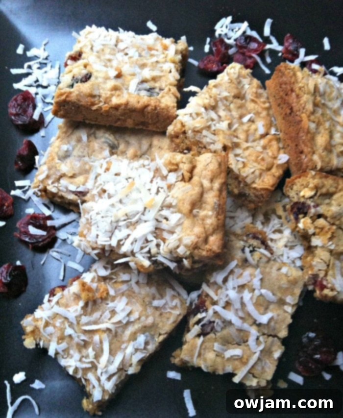 Delicious Chewy Coconut Cranberry Oatmeal Bars on a wooden board