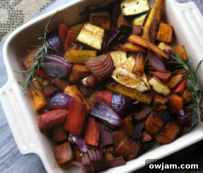 A colorful medley of Rosemary and Lemon Roasted Vegetables on a baking sheet, fresh out of the oven, ready to be served as a healthy side dish.