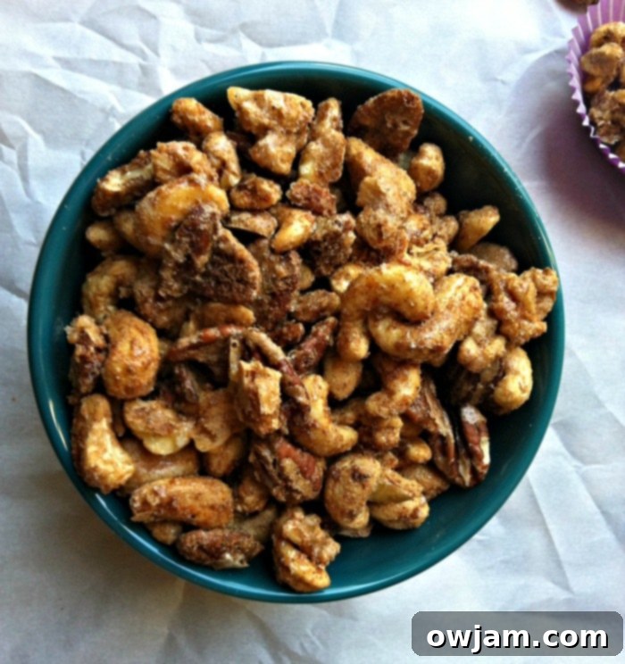 Sweet Heat Nut Medley 4 Sweet and Spicy Nut Mix in a white bowl with a spoon