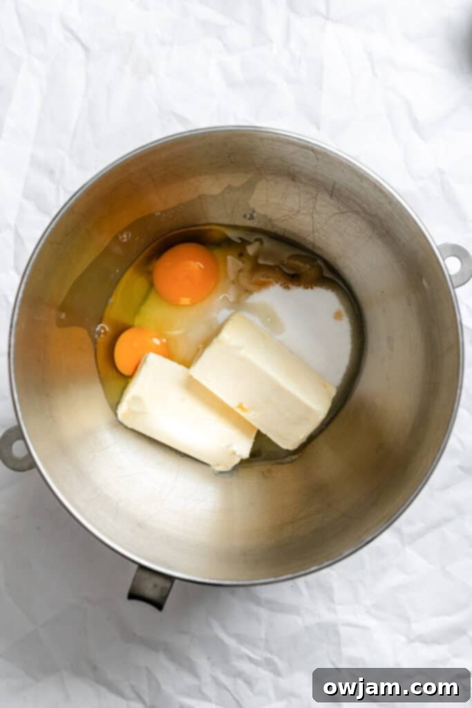 Quick and Easy Snickerdoodle Recipe 5 Wet ingredients for snickerdoodles in a mixing bowl: softened butter, sugar, vanilla extract, and eggs.