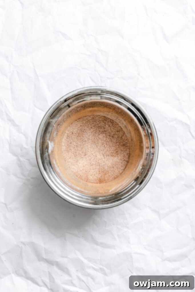 Quick and Easy Snickerdoodle Recipe 8 Small bowl with cinnamon and sugar mixed for the snickerdoodle coating.