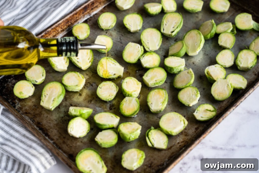 Roasted Brussels sprouts, possibly with balsamic glaze, on a baking sheet