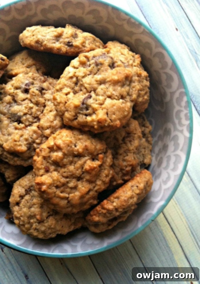 Close-up of a stack of golden brown chewy oatmeal chocolate chip cookies
