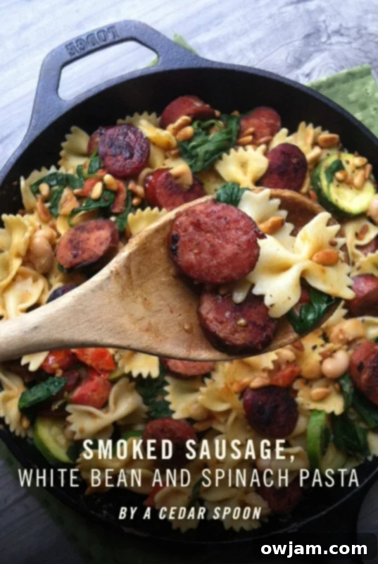 Smoked Sausage Pasta with White Beans, Spinach, and Toasted Pine Nuts