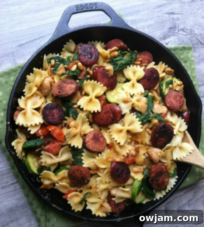 Hearty Smoked Sausage and White Bean Pasta 4 Smoked Sausage, White Bean and Spinach Pasta with Toasted Pine Nuts in a rustic bowl.