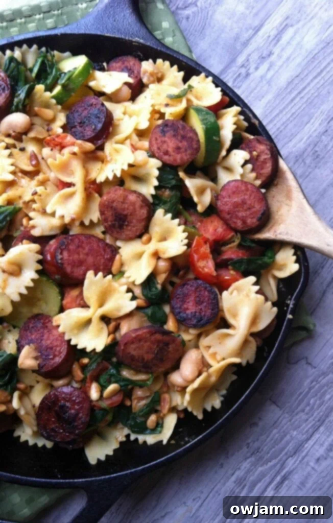 Hearty Smoked Sausage and White Bean Pasta 5 Smoked Sausage Pasta with White Beans, Spinach, and Toasted Pine Nuts served in a bowl.