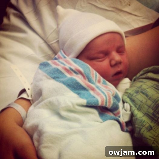 Newborn baby Drew sleeping soundly in a cozy swaddle