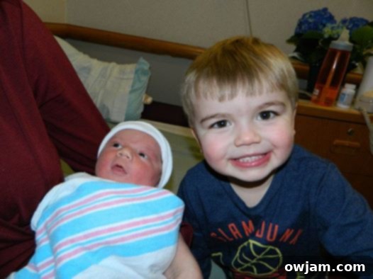 Big brother Will gently looking at baby Andrew in a sweet moment