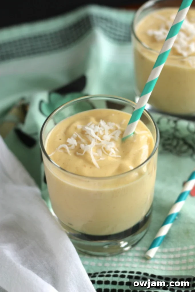 Close-up of a refreshing Coconut Mango Smoothie with a straw.