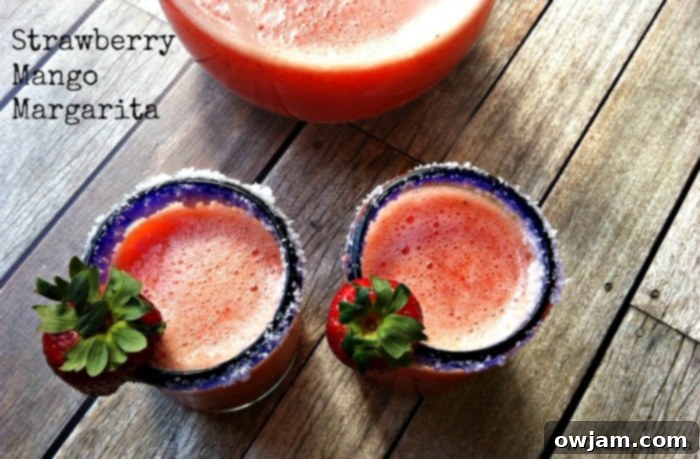 Tropical Strawberry Mango Margarita 2 Vibrant Strawberry Mango Margarita in a glass, ready to be enjoyed on a sunny day
