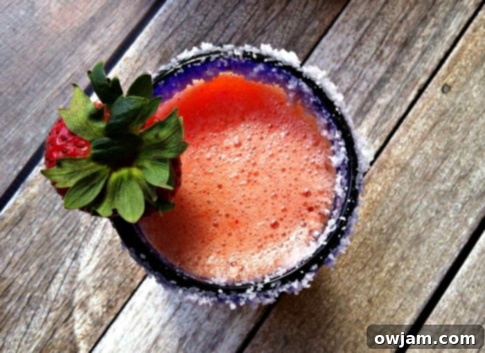 Tropical Strawberry Mango Margarita 4 Pitcher of Strawberry Mango Margarita with glasses and fresh fruit