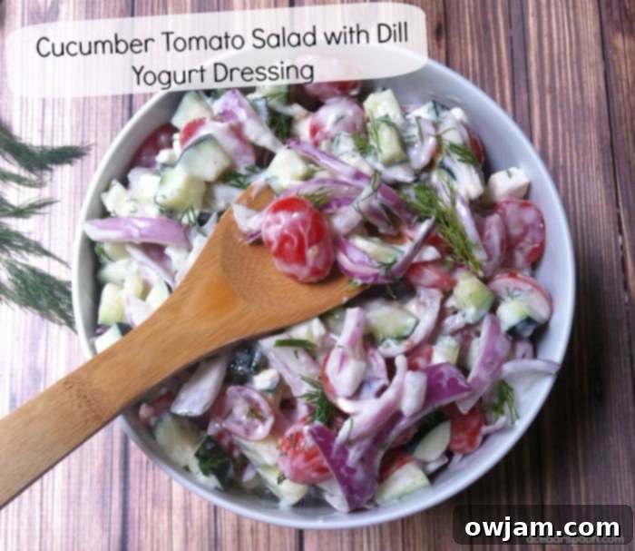 Vibrant Cucumber Tomato Salad with Zesty Dill Yogurt 2 Refreshing Cucumber Tomato Salad with Creamy Dill Yogurt Dressing, garnished with fresh dill.