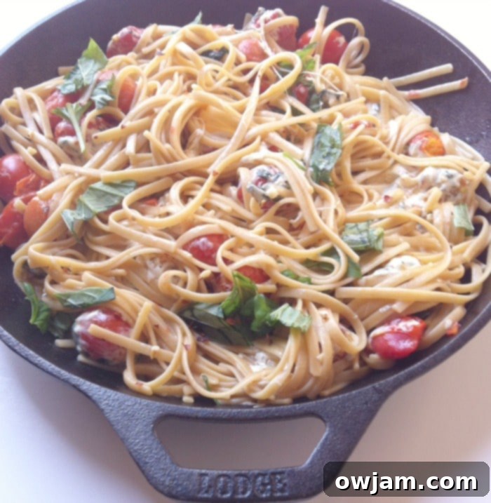 Close-up of freshly cooked Caprese Pasta Skillet with melted mozzarella and bright basil