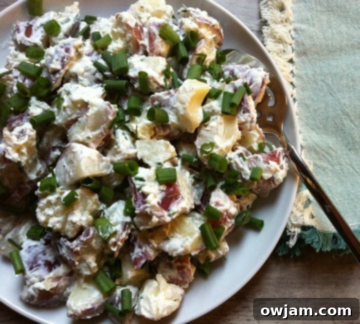 Potato Salad with Dill Chive Yogurt Dressing served in a bowl, garnished with fresh herbs
