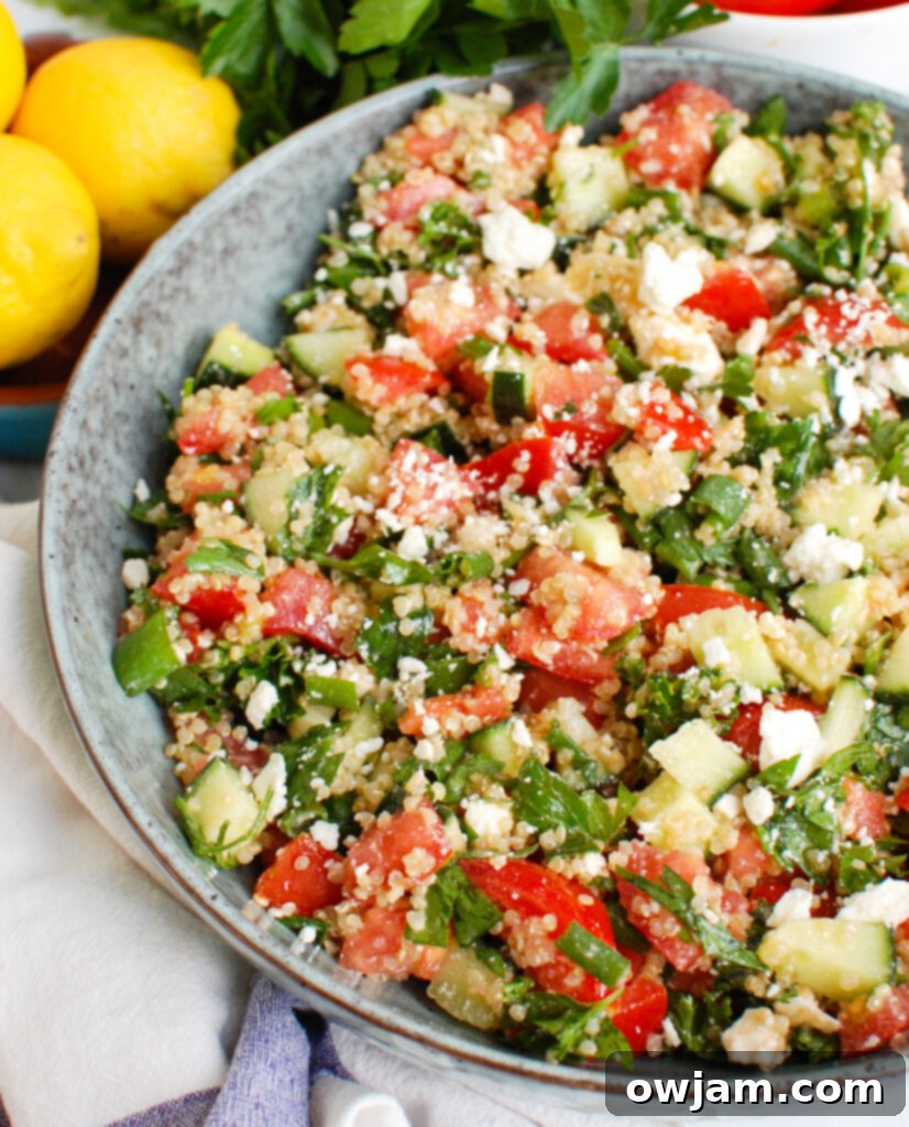 Bright Mediterranean Quinoa Salad 3 Tomato Cucumber Feta Quinoa Salad in a beautiful blue bowl