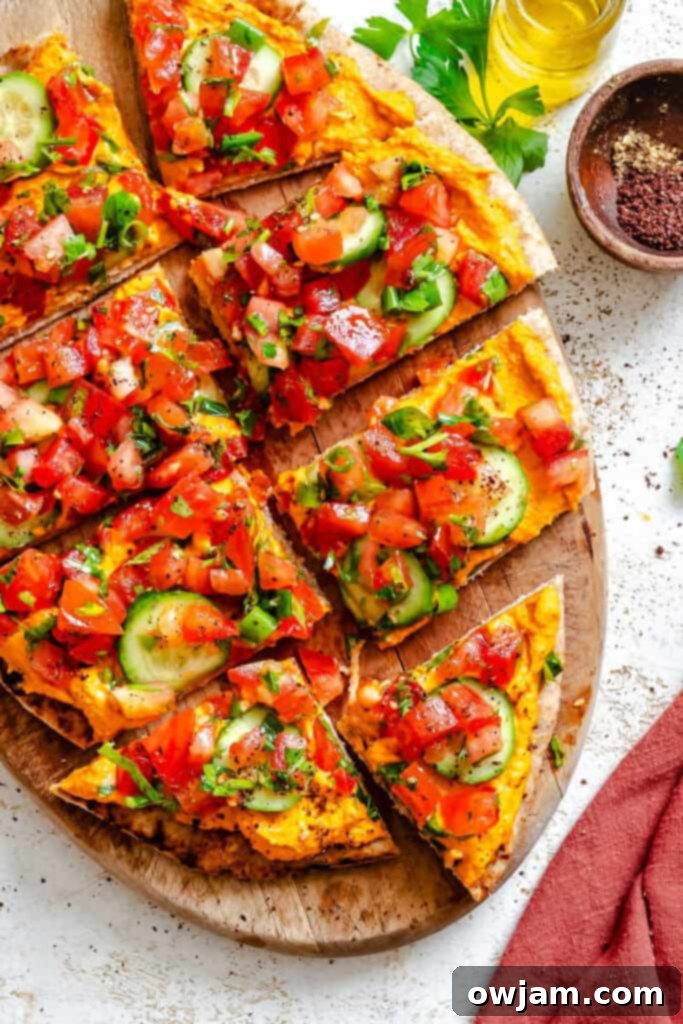 Mediterranean-Inspired Naan Pizza 2 Mediterranean Naan Pizza on a wooden plate