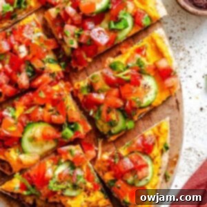 Mediterranean-Inspired Naan Pizza 9 Mediterranean Naan Pizza with roasted red pepper hummus and fresh vegetables