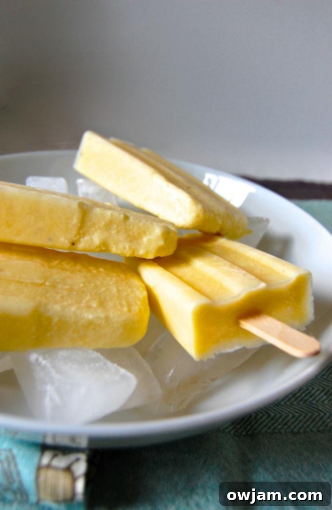 Virgin Pina Colada Popsicles 3 Homemade Pina Colada Popsicles in molds, vibrant and ready for freezing
