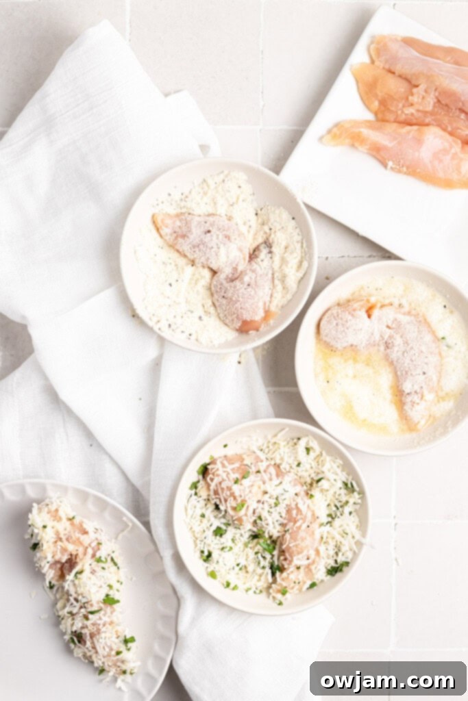 Chicken tenderloins being coated in a mixture of shredded coconut and cilantro.