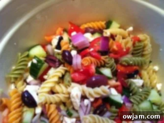 Close-up of Greek Pasta Salad mixed and tossed with dressing