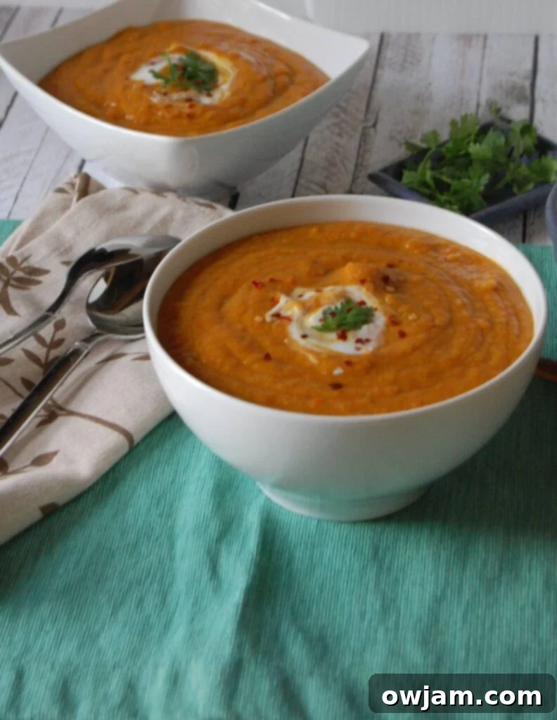 A close-up of Moroccan Carrot Red Lentil Soup, ready to be enjoyed, highlighting its rich texture and color.