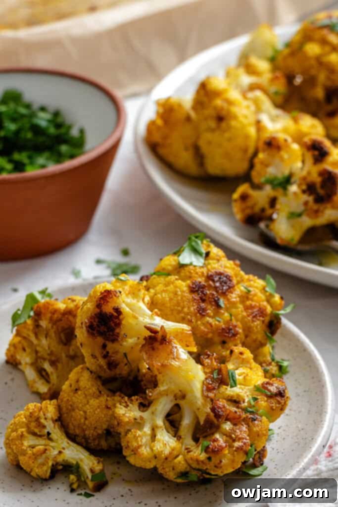 Golden Curry Roasted Cauliflower 5 Single serving of Curry Roasted Cauliflower presented on a white plate