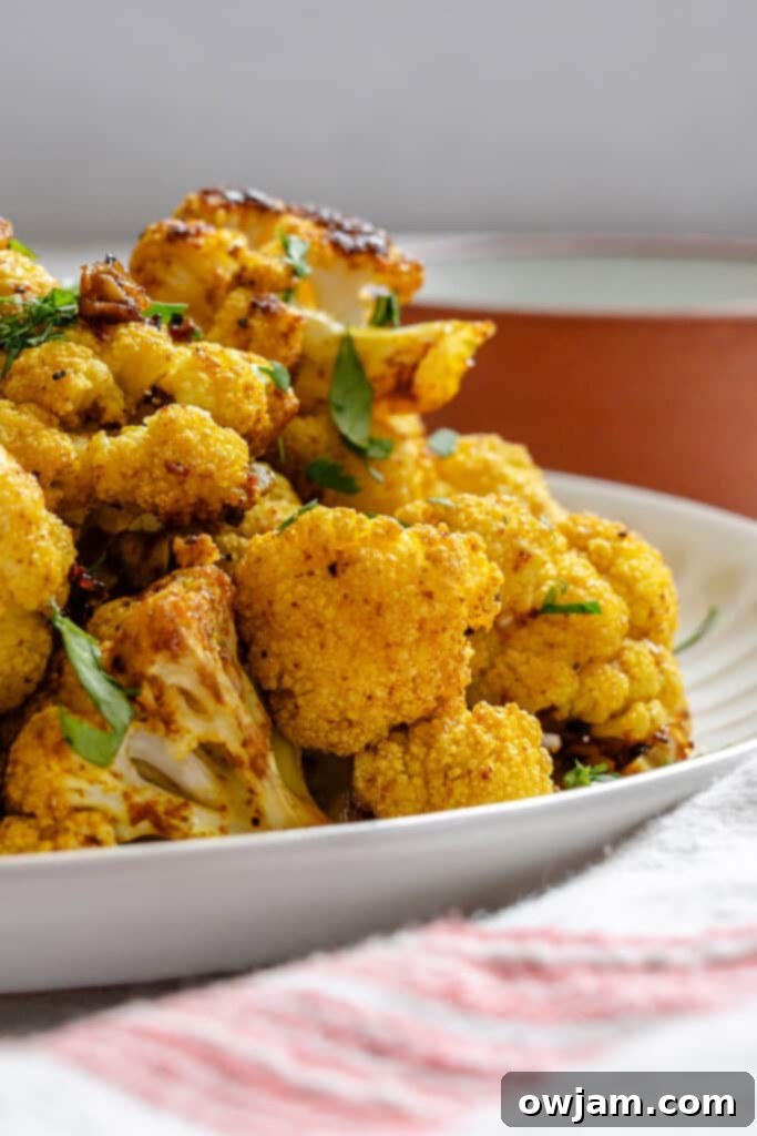Golden Curry Roasted Cauliflower 6 Close-up of roasted Curry Cauliflower florets, showing crispy edges and rich spice coating