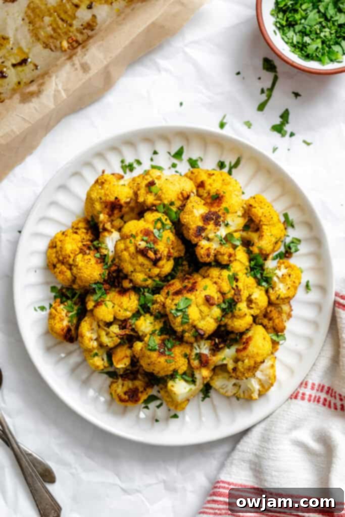Golden Curry Roasted Cauliflower 10 A dish of Curry Roasted Cauliflower ready to be served, highlighting its rich color and fresh garnish