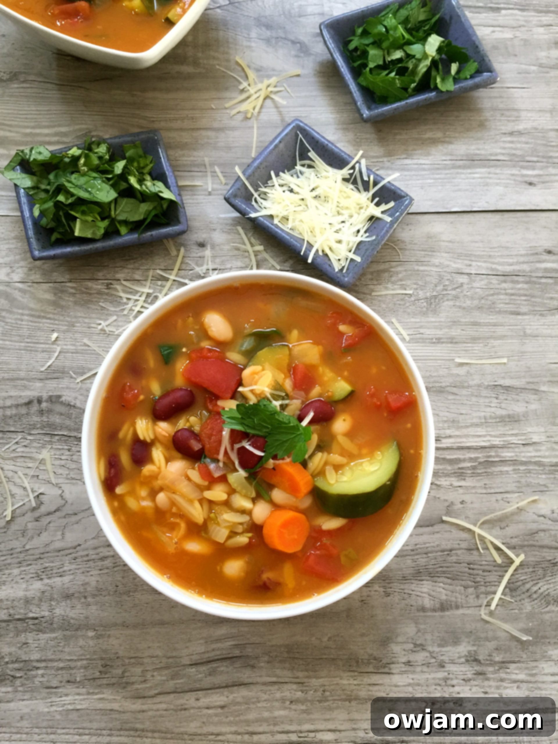 A close-up view of Orzo Minestrone Soup, showing the texture of orzo pasta and vibrant vegetables