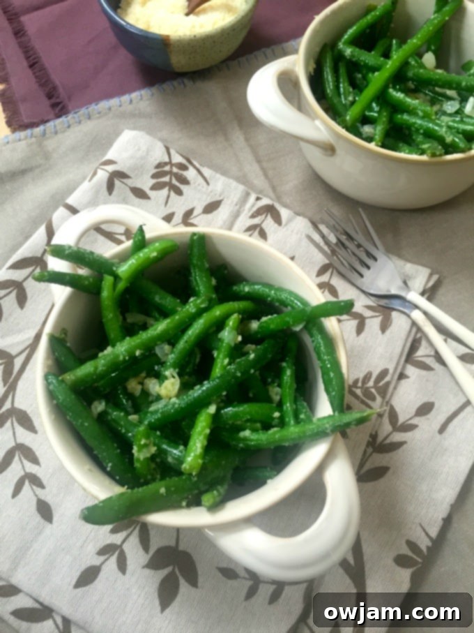A plate of simple garlic parmesan green beans, perfect as a healthy side.