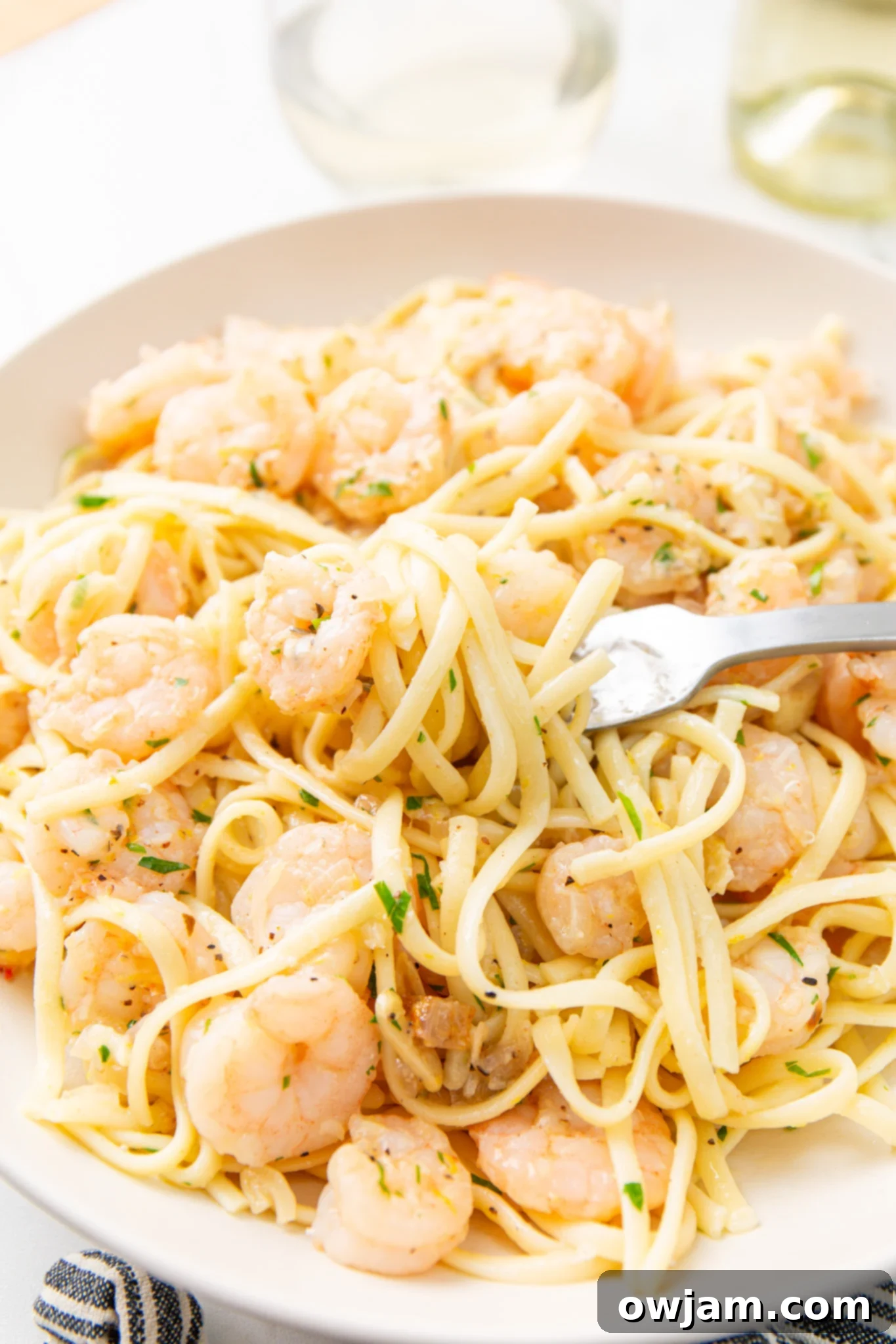 Zesty Lemon Garlic Shrimp Pasta 3 Lemon Garlic Shrimp Pasta with a fork twirled into the pasta, ready to eat.