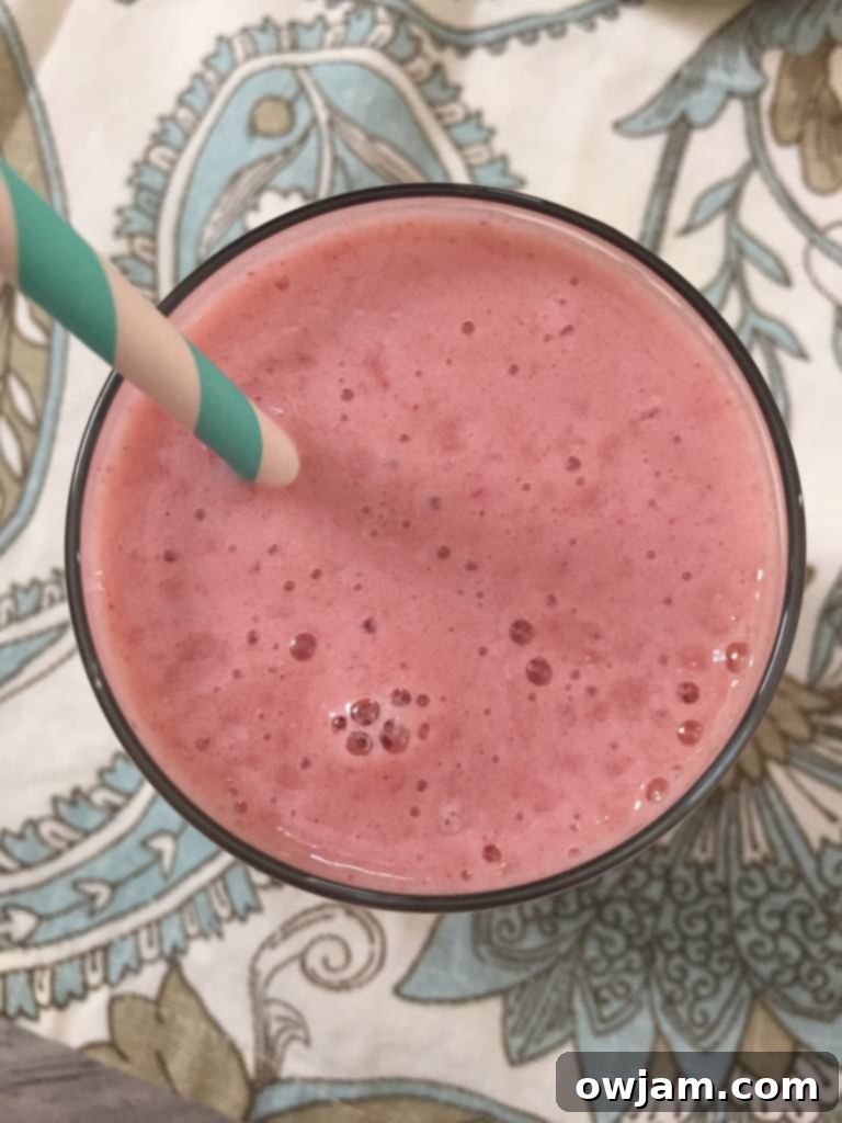Close-up of a Strawberry Cantaloupe Smoothie showing its fresh ingredients and smooth texture.