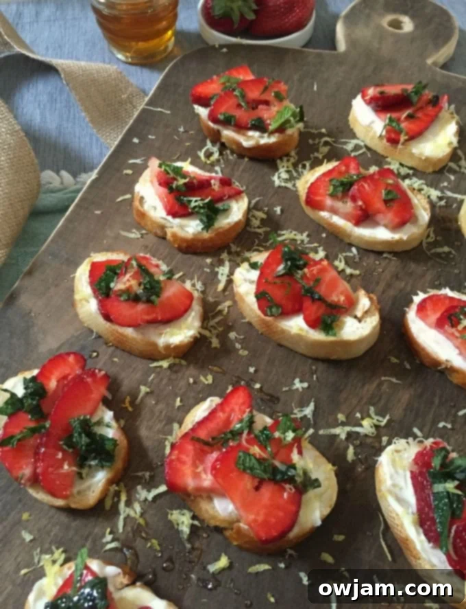 Strawberry Mint Mascarpone Crostini with Zesty Honey Drizzle 2 Freshly prepared Strawberry Mint Crostini with Lemon Honey Drizzle, beautifully arranged on a serving platter.