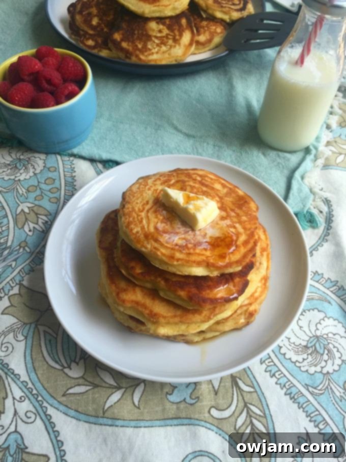 Stack of Tenderest Cardamom Pancakes topped with berries