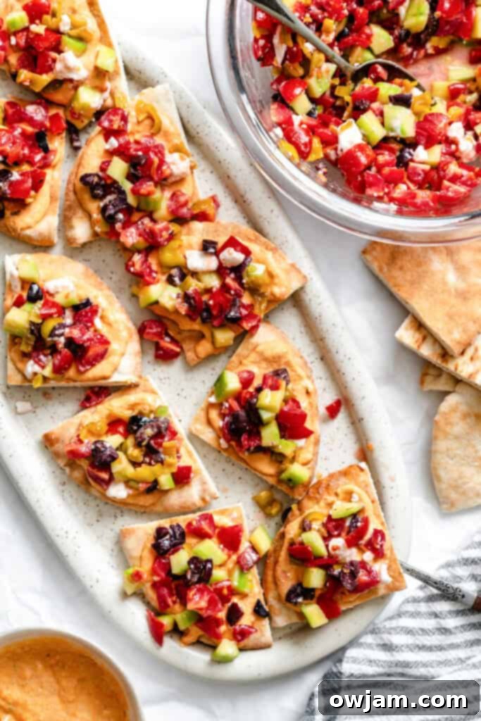 Loaded Hummus Pitas on a white plate 