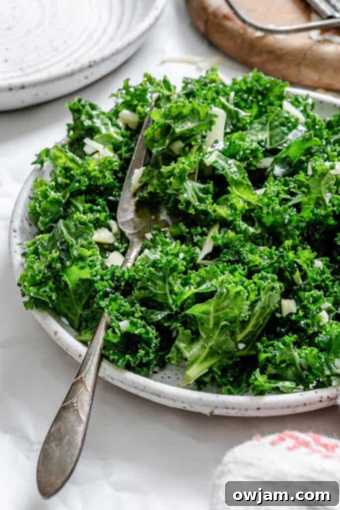 Kale Salad with Lemon Dressing with fork on a white plate