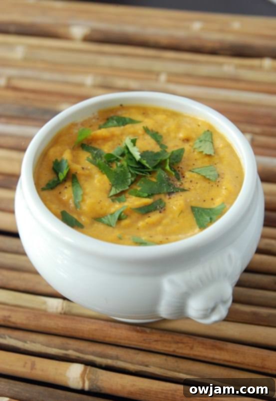 A vibrant bowl of Sweet Potato Coconut Curry Soup, creamy and aromatic.