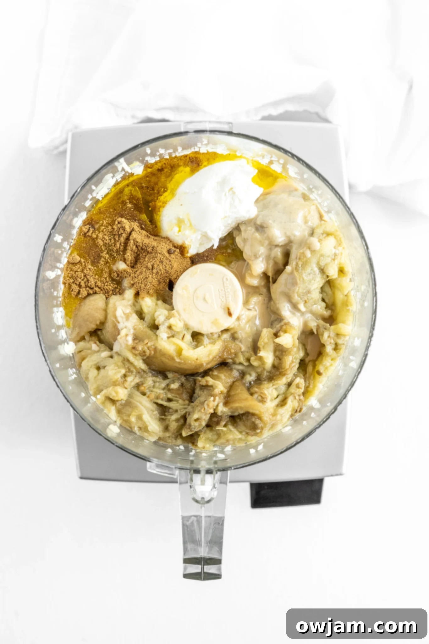 Ingredients for Baba Ghanoush being pureed in a food processor.