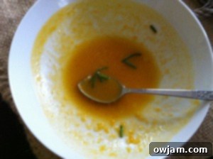 Another inviting image of a serving of Roasted Butternut Squash Soup on a wooden surface
