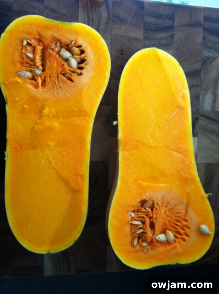 Butternut squash cut in half, showcasing the preparation for roasting in the oven