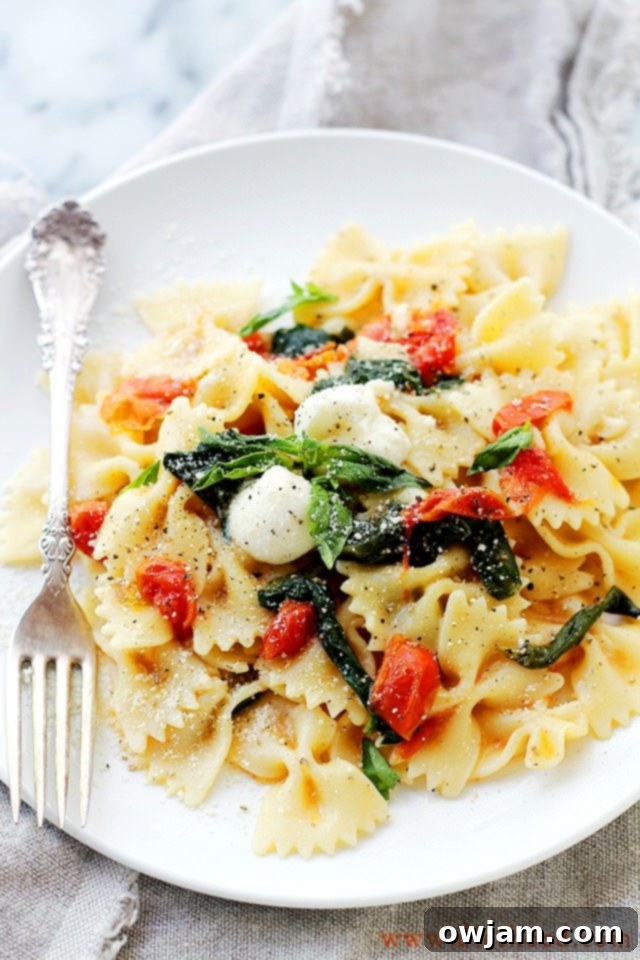 Delicious One-Pot Caprese Pasta Skillet with fresh tomatoes, mozzarella, and basil.