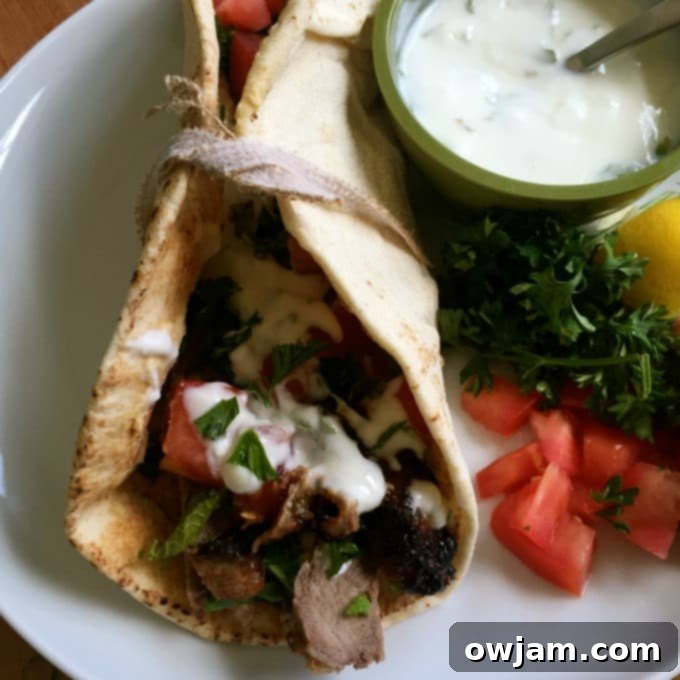 Mediterranean Steak Pita Wraps with Mint Yogurt Sauce on plate. 