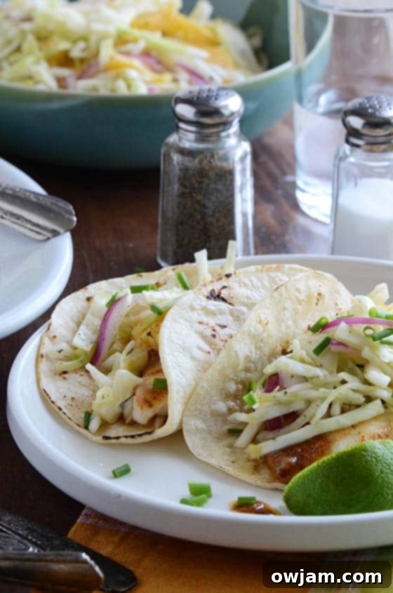 Flavorful ancho-garlic fish tacos with bright citrus-mango slaw