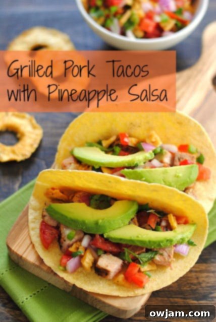 Smoky grilled pork tacos topped with sweet pineapple salsa