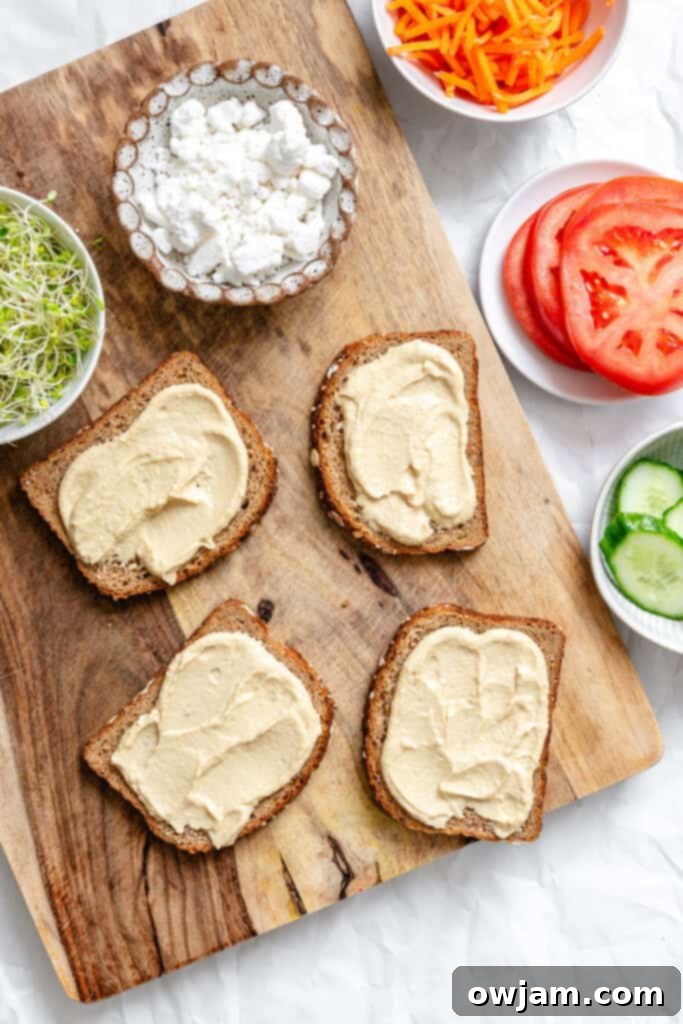 Mediterranean Garden Sandwich 7 Hummus being spread on a slice of bread