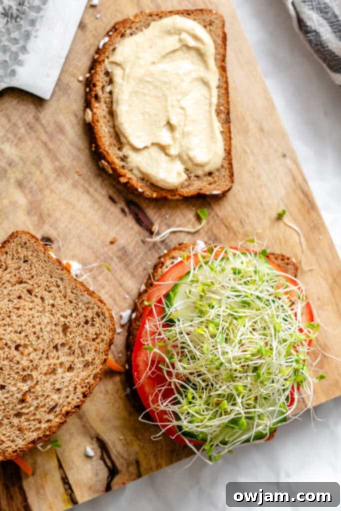 Mediterranean Garden Sandwich 9 Sprouts being added as the final layer on the sandwich