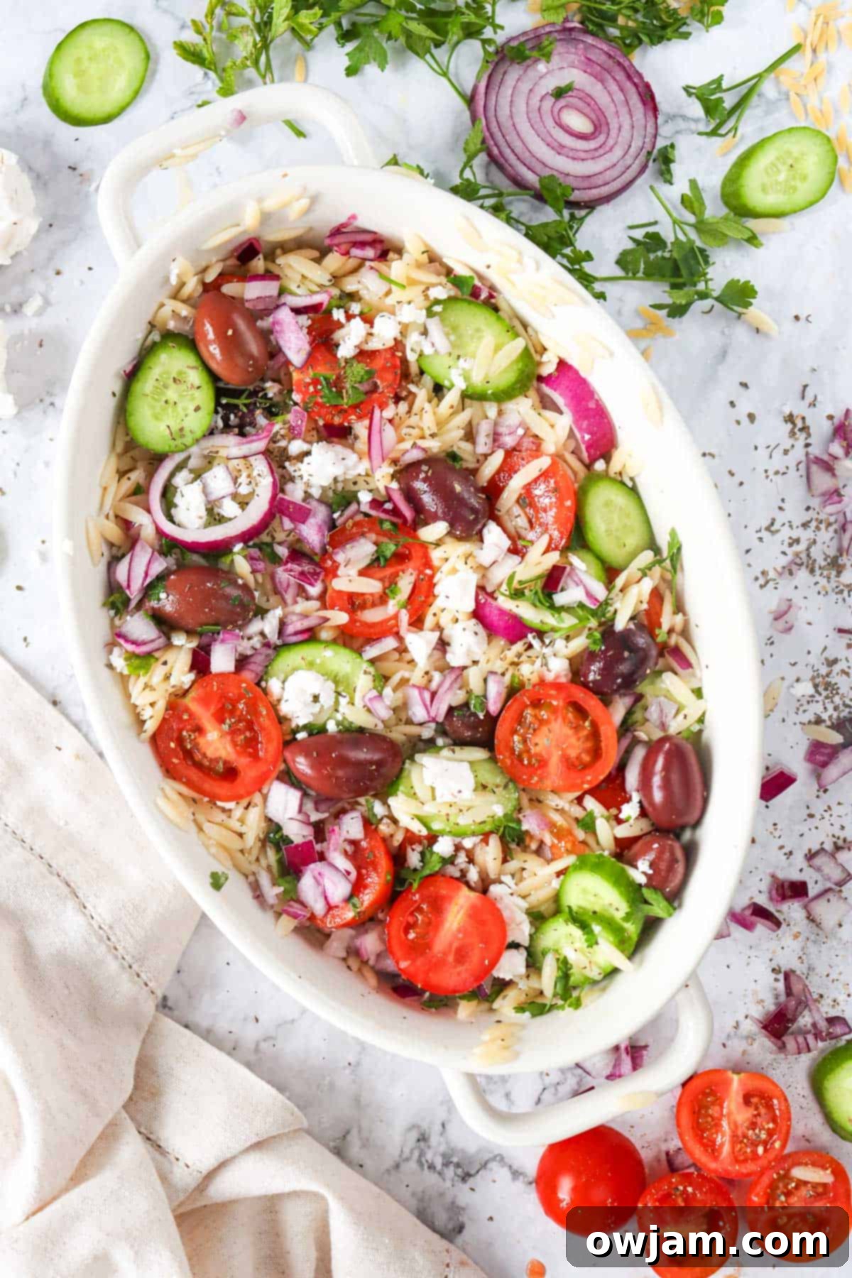 Greek Orzo Pasta Salad in white bowls, ready to serve.
