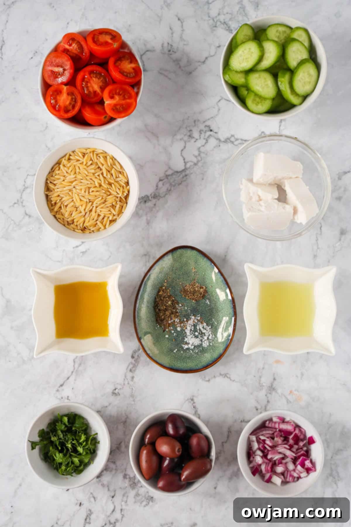 Zesty Mediterranean Orzo Salad 3 Greek Orzo Pasta Salad ingredients laid out on a table.